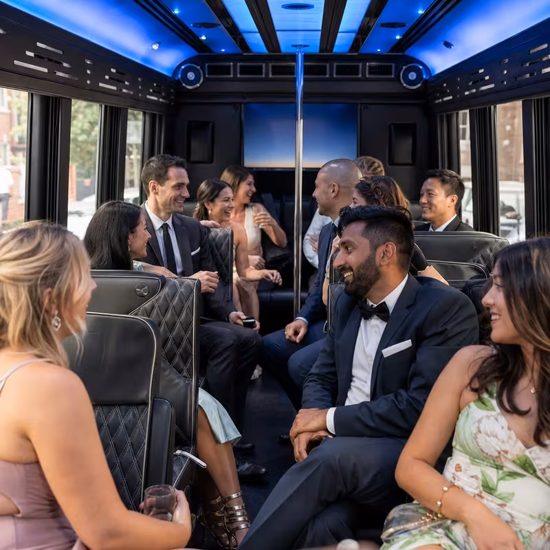 Wedding guests seated inside a New York party bus