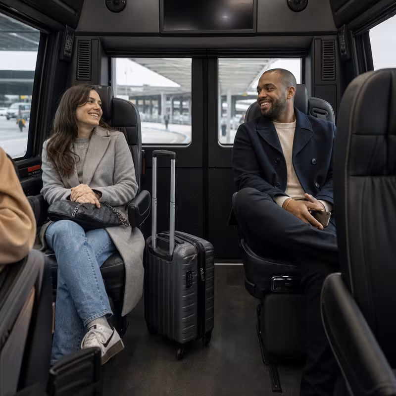 Passengers loading luggage while boarding an New York group shuttle
