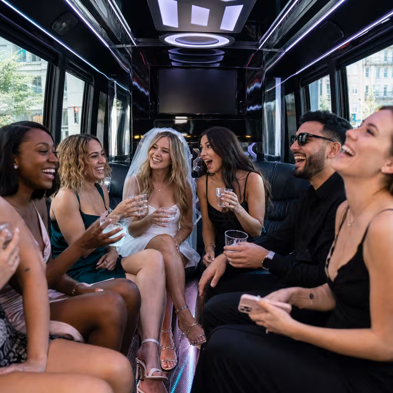 Party bus interior with wraparound leather seating and LED lighting in New York