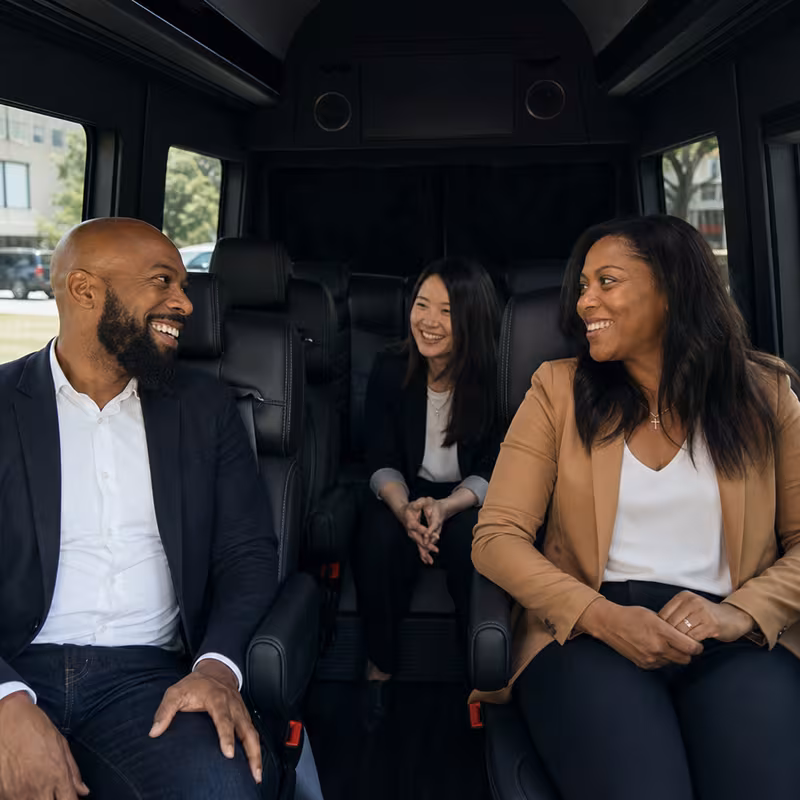 Group boarding a white charter bus for Corporate Transportation transportation in New York