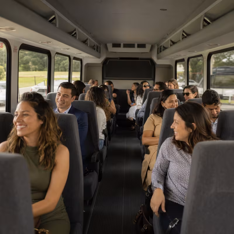 Group boarding a white charter bus for Private Event Transportation transportation in New York