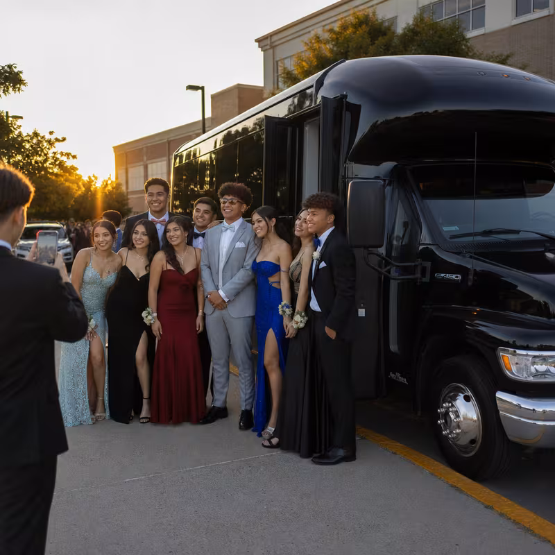 Group boarding a white charter bus for Prom & Homecoming Transportation transportation in New York
