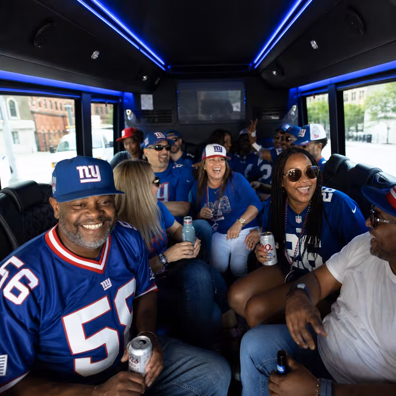 Group boarding a white charter bus for Sporting Event Transportation transportation in New York