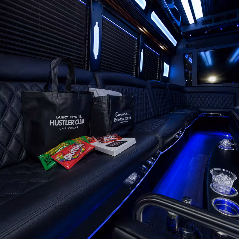 Party bus interior with wraparound leather seating and LED lighting in New York